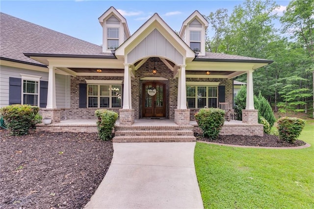 7269 Tyree Rd, Winston, GA 30187 - view of front of house featuring covered porch, brick siding, board and batten siding, and a front yard