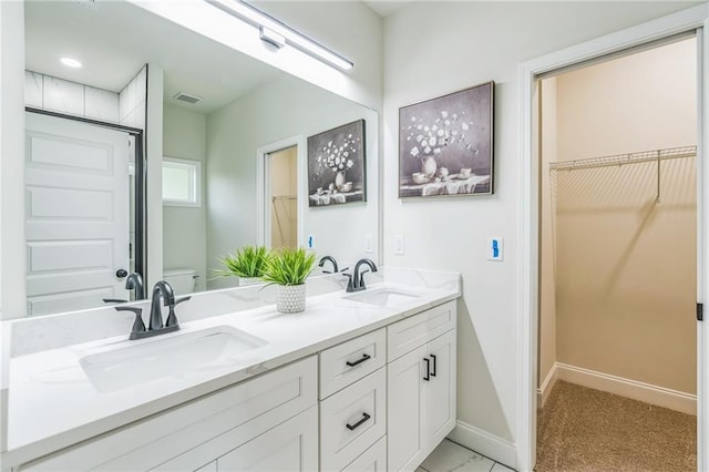 623 Hamilton E Holmes Dr NW, Atlanta, GA 30318 - bathroom with double vanity, a spacious closet, and a shower
