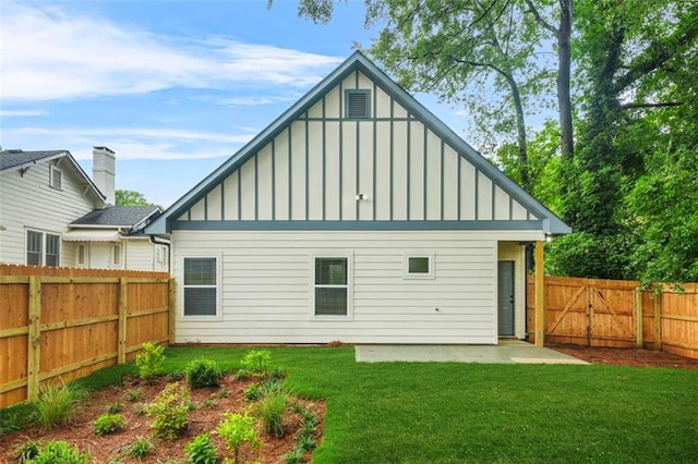 623 Hamilton E Holmes Dr NW, Atlanta, GA 30318 - back of house featuring board and batten siding, a fenced backyard, a patio, and a gate