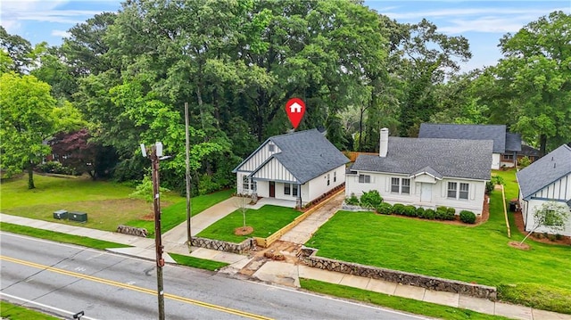 623 Hamilton E Holmes Dr NW, Atlanta, GA 30318 - view of front facade featuring a chimney, concrete driveway, a front lawn, a shingled roof, and covered porch