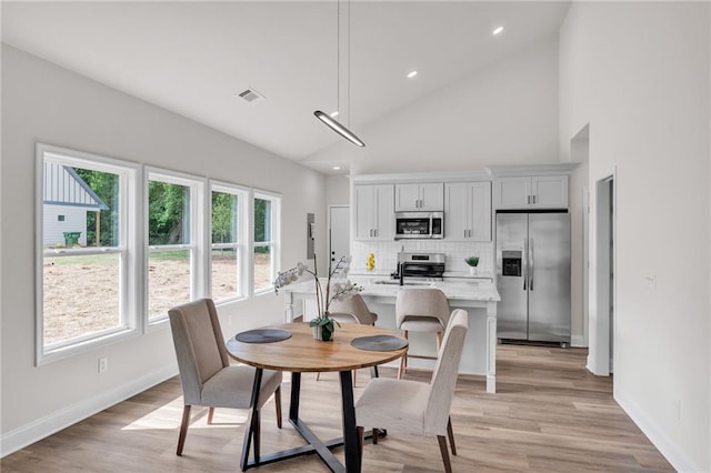 623 Hamilton E Holmes Dr NW, Atlanta, GA 30318 - dining space featuring light wood-style floors, high vaulted ceiling, and recessed lighting