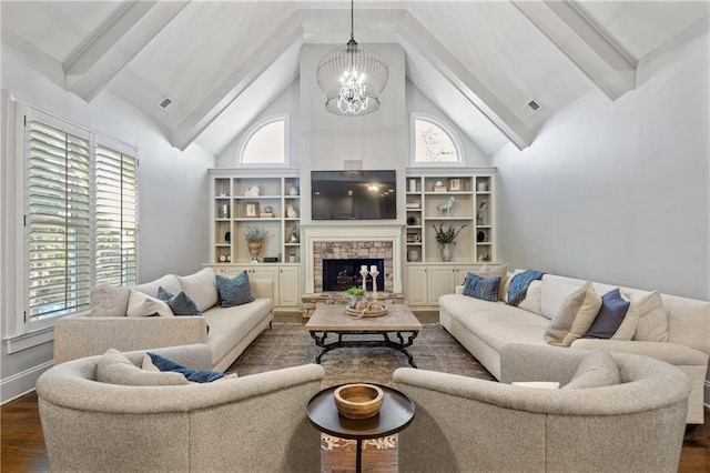 living area featuring dark wood-style flooring, a notable chandelier, a fireplace, high vaulted ceiling, and a wealth of natural light