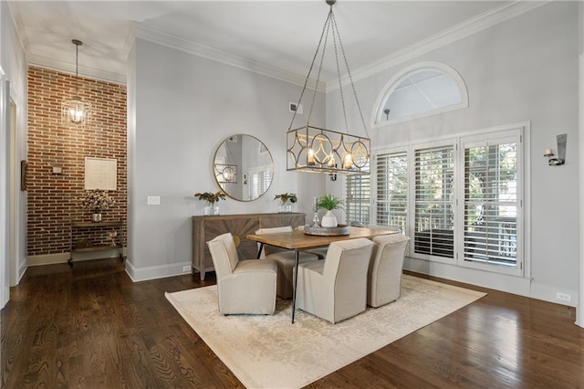 dining area featuring crown molding, a high ceiling, wood finished floors, and a notable chandelier