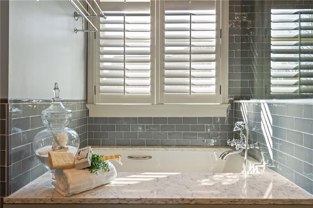 full bath featuring a washtub and plenty of natural light