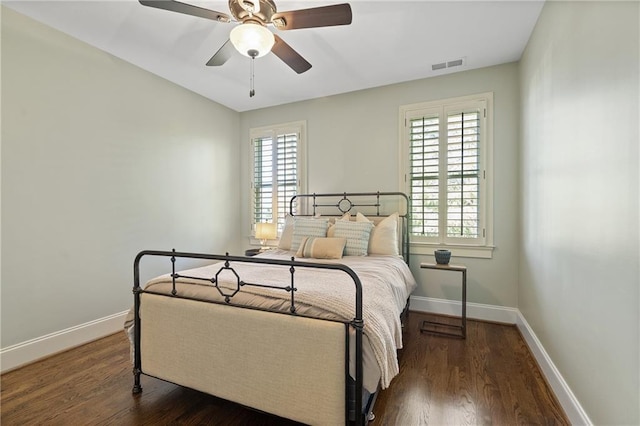 bedroom with baseboards, visible vents, and dark wood-style flooring