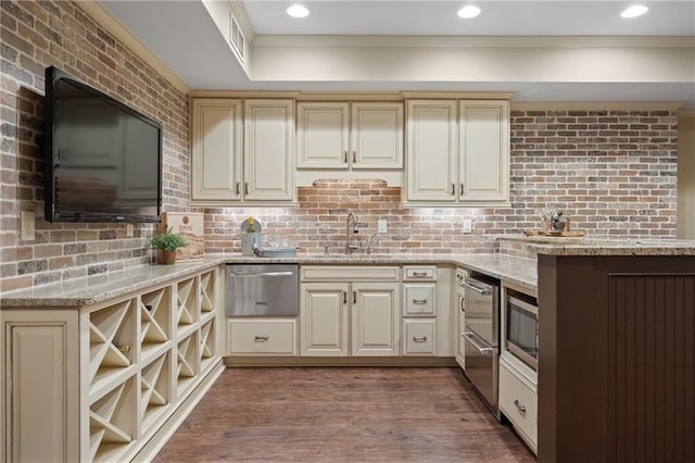 kitchen featuring cream cabinets, a sink, and a warming drawer