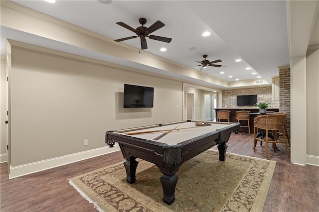 game room featuring a tray ceiling, baseboards, recessed lighting, and wood finished floors