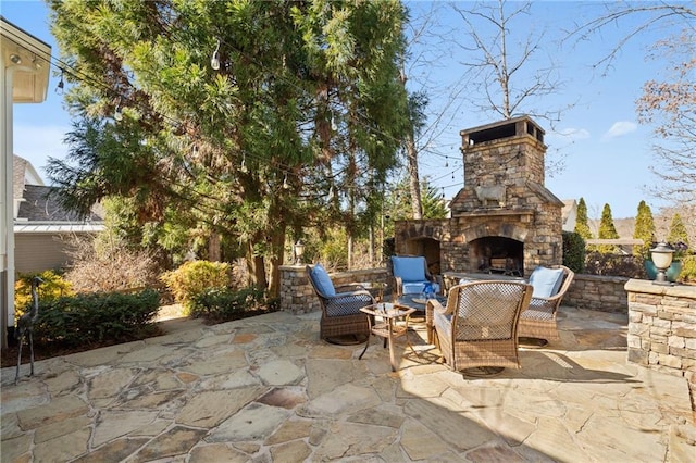 view of patio / terrace featuring an outdoor stone fireplace