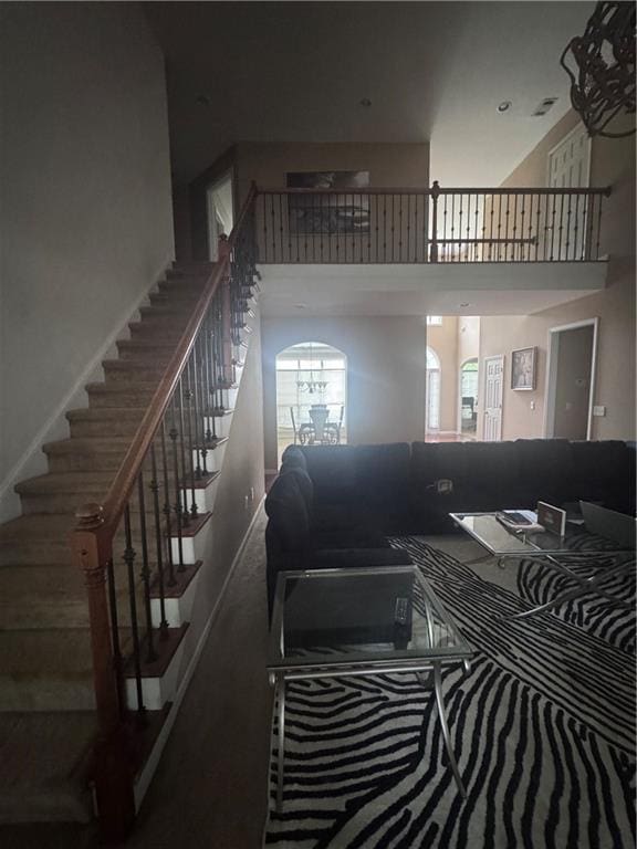 458 Vinings Vintage Cir, Mableton, GA 30126 - staircase featuring a towering ceiling and carpet