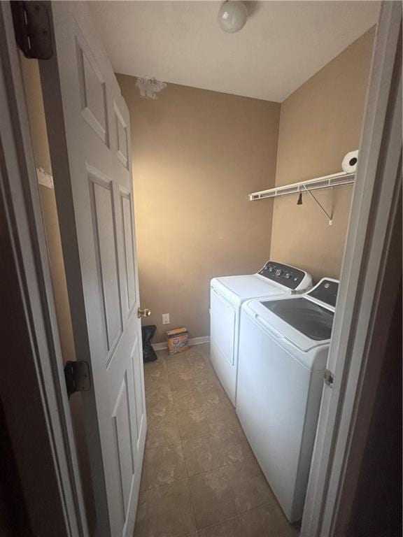 458 Vinings Vintage Cir, Mableton, GA 30126 - laundry area with independent washer and dryer, tile patterned flooring, and baseboards
