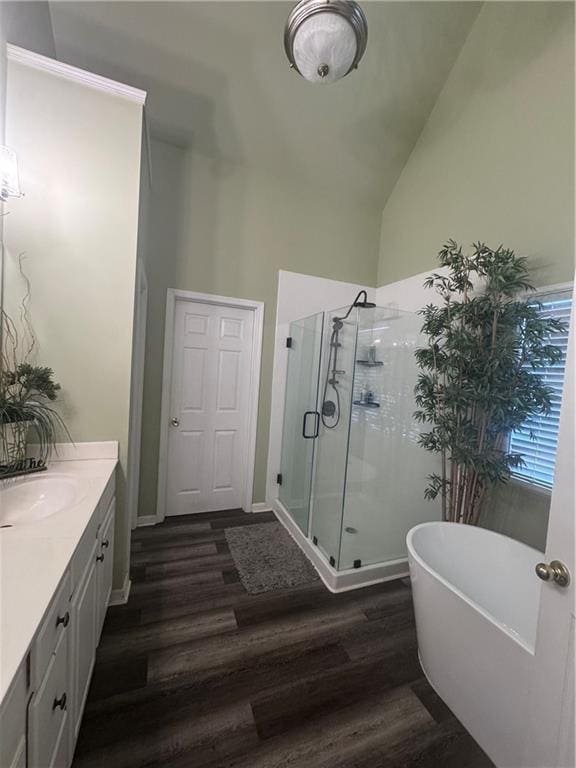 458 Vinings Vintage Cir, Mableton, GA 30126 - full bath featuring wood finished floors, vanity, a stall shower, a freestanding tub, and vaulted ceiling