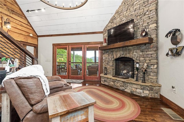 living room with dark wood-type flooring, a stone fireplace, wood ceiling, and vaulted ceiling