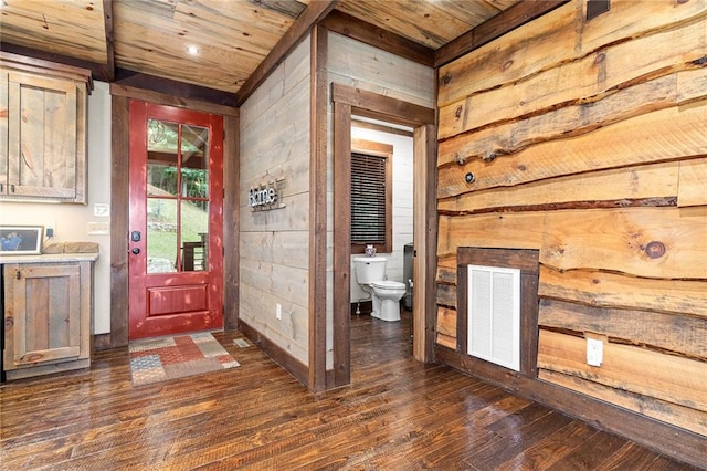 entrance foyer with wood ceiling, wood walls, and dark hardwood / wood-style floors