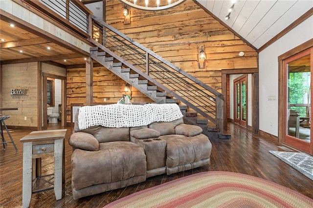 living room featuring vaulted ceiling, dark hardwood / wood-style flooring, wooden walls, and wood ceiling