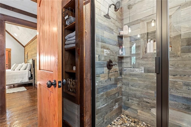 bathroom featuring vanity, vaulted ceiling, toilet, hardwood / wood-style flooring, and wooden walls