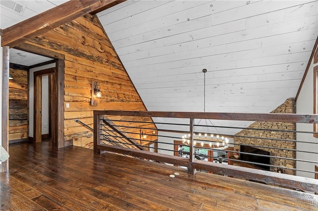 bathroom with ornamental molding, lofted ceiling, a tile shower, and wood-type flooring