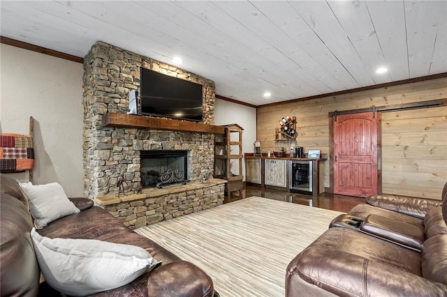 living room featuring concrete flooring, ornamental molding, and a stone fireplace