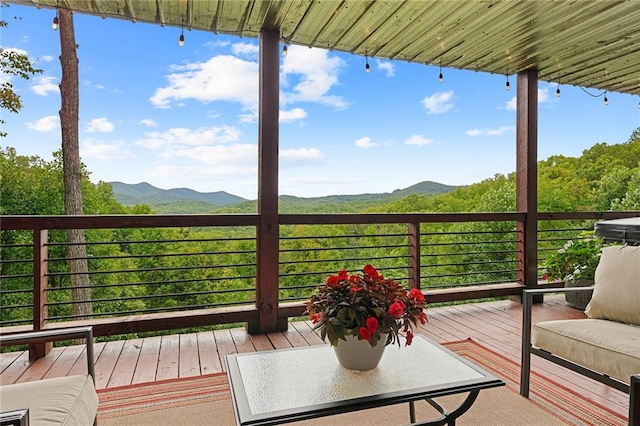 wooden deck with a mountain view and a hot tub