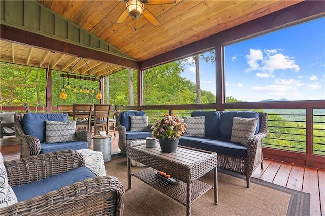 sunroom with ceiling fan, wooden ceiling, and vaulted ceiling