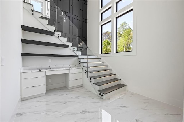 4238 Hamilton Mill Rd, Buford, GA 30519 - stairway with marble look tile flooring, plenty of natural light, and a high ceiling