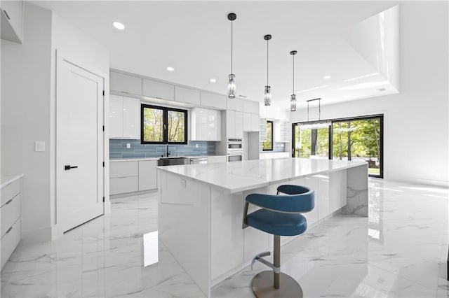4238 Hamilton Mill Rd, Buford, GA 30519 - kitchen with modern cabinets, light marble finish flooring, white cabinets, a sink, and recessed lighting