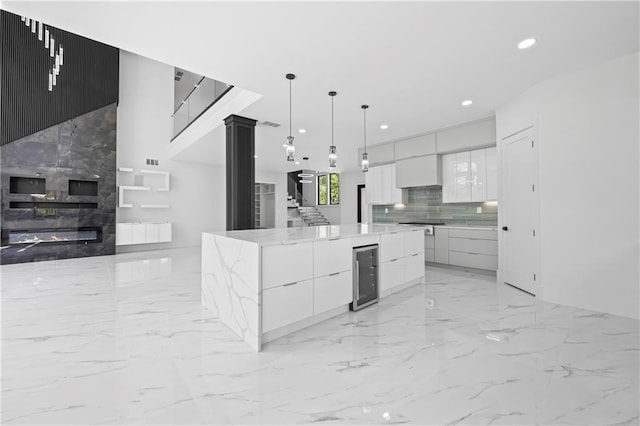 4238 Hamilton Mill Rd, Buford, GA 30519 - kitchen with modern cabinets, light marble finish flooring, recessed lighting, wine cooler, and white cabinetry