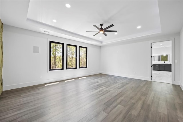 4238 Hamilton Mill Rd, Buford, GA 30519 - unfurnished living room featuring a raised ceiling, a ceiling fan, wood finished floors, recessed lighting, and baseboards