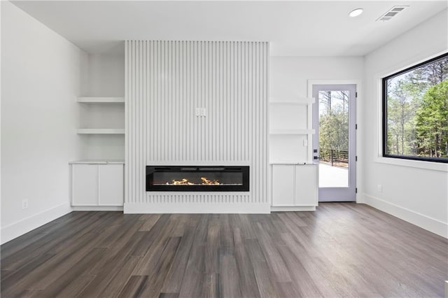 4238 Hamilton Mill Rd, Buford, GA 30519 - unfurnished living room featuring a glass covered fireplace, dark wood-style flooring, baseboards, and recessed lighting