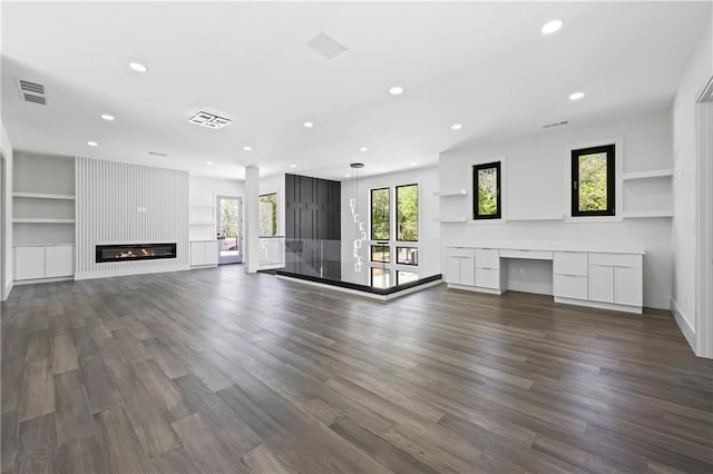 4238 Hamilton Mill Rd, Buford, GA 30519 - unfurnished living room with recessed lighting, dark wood-type flooring, a fireplace, built in shelves, and baseboards