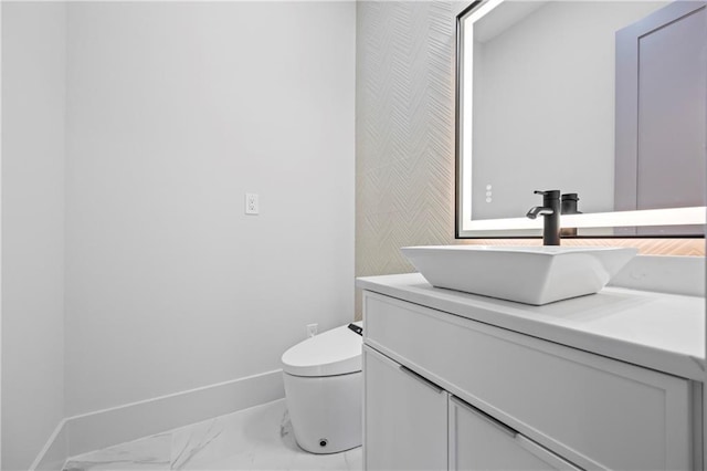 4238 Hamilton Mill Rd, Buford, GA 30519 - half bathroom with marble look tile flooring, baseboards, vanity, and toilet