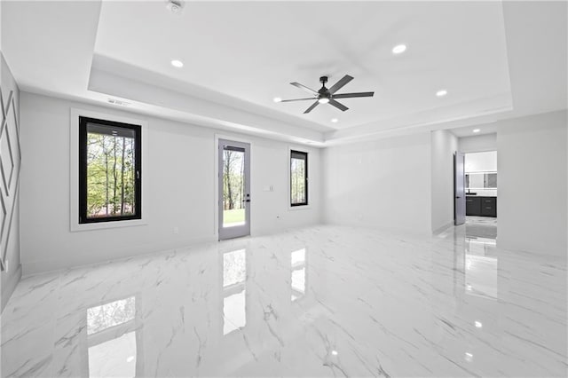 4238 Hamilton Mill Rd, Buford, GA 30519 - empty room with a raised ceiling, recessed lighting, ceiling fan, and marble tiled flooring