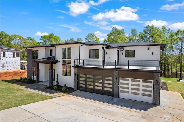 4238 Hamilton Mill Rd, Buford, GA 30519 - contemporary house featuring a balcony, stone siding, stucco siding, driveway, and a garage