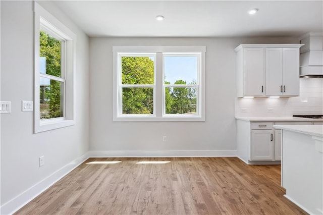 4002 Adler Cir, Buford, GA 30519 - kitchen featuring white cabinets, plenty of natural light, and light wood finished floors