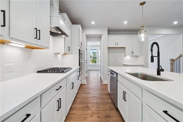 4002 Adler Cir, Buford, GA 30519 - kitchen with wood finished floors, a sink, appliances with stainless steel finishes, white cabinetry, and custom range hood