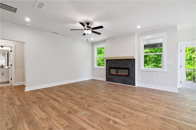4002 Adler Cir, Buford, GA 30519 - unfurnished living room with a fireplace, light wood-style floors, and visible vents