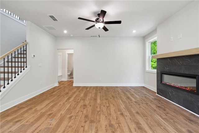 4002 Adler Cir, Buford, GA 30519 - unfurnished living room featuring stairway, a ceiling fan, wood finished floors, a tile fireplace, and visible vents