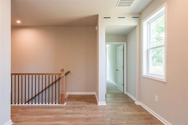 corridor with light hardwood / wood-style flooring