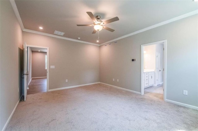 empty room with ceiling fan, ornamental molding, and light carpet