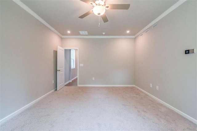 carpeted empty room featuring ceiling fan and ornamental molding