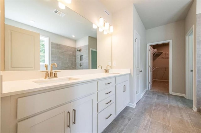 bathroom with vanity and tiled shower