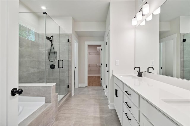 4002 Adler Cir, Buford, GA 30519 - full bath featuring a sink, double vanity, a spacious closet, a shower stall, and a garden tub