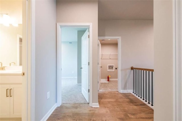 hall featuring light wood-type flooring and sink