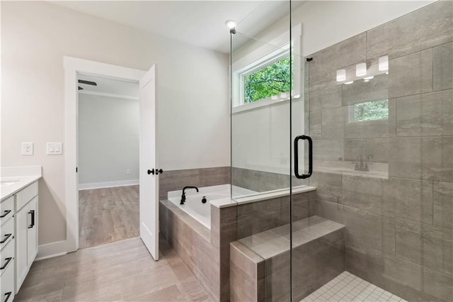 4002 Adler Cir, Buford, GA 30519 - bathroom featuring a garden tub, vanity, tile patterned flooring, and a stall shower
