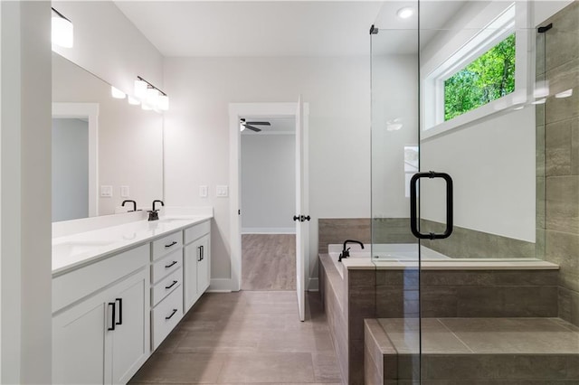 4002 Adler Cir, Buford, GA 30519 - bathroom with a ceiling fan, a sink, a stall shower, a bath, and double vanity