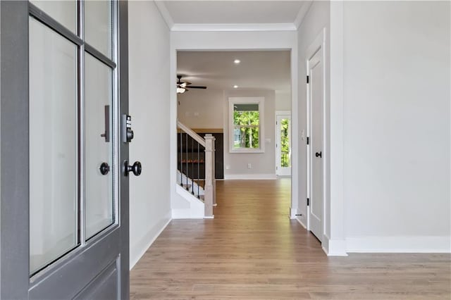 4002 Adler Cir, Buford, GA 30519 - entryway featuring stairway, crown molding, light wood-style floors, ceiling fan, and baseboards