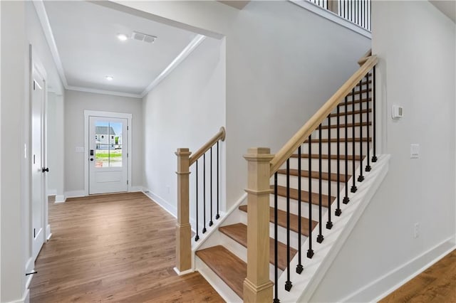 4002 Adler Cir, Buford, GA 30519 - foyer featuring stairway, crown molding, wood finished floors, baseboards, and visible vents