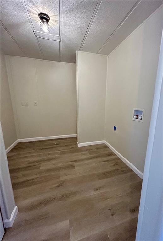 laundry area featuring washer hookup, a textured ceiling, wood finished floors, laundry area, and baseboards