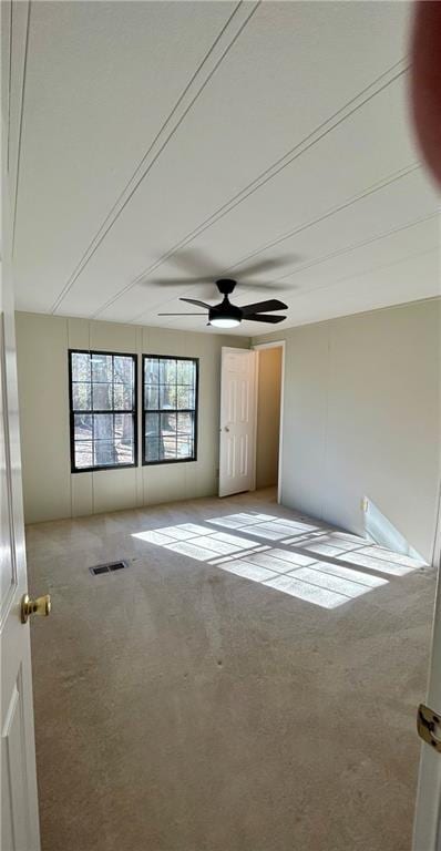 spare room with light carpet and visible vents