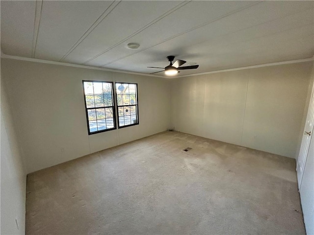 unfurnished room with crown molding, light colored carpet, and ceiling fan