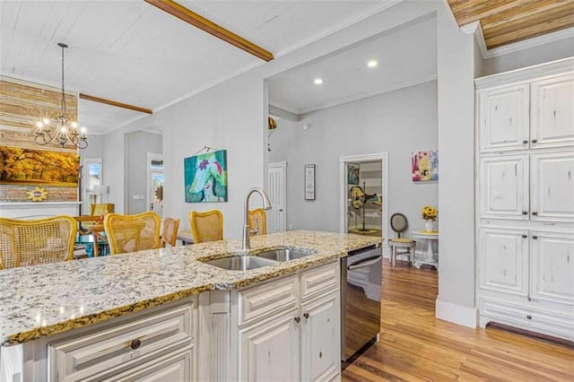 kitchen with dishwasher, sink, ornamental molding, a notable chandelier, and white cabinetry